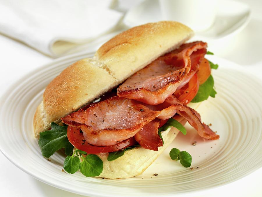 A Bread Roll Filled With Bacon, Tomatoes, Rocket And Watercress Photograph by Robert Morris