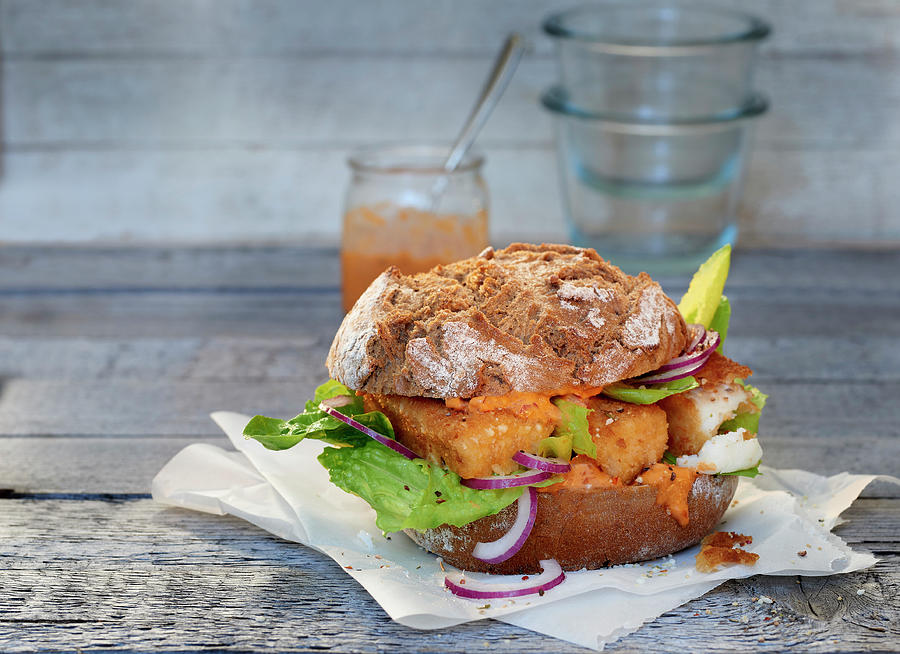 A Bread Roll With Cod Fingers On Paper Photograph by Stefan Schulte-ladbeck