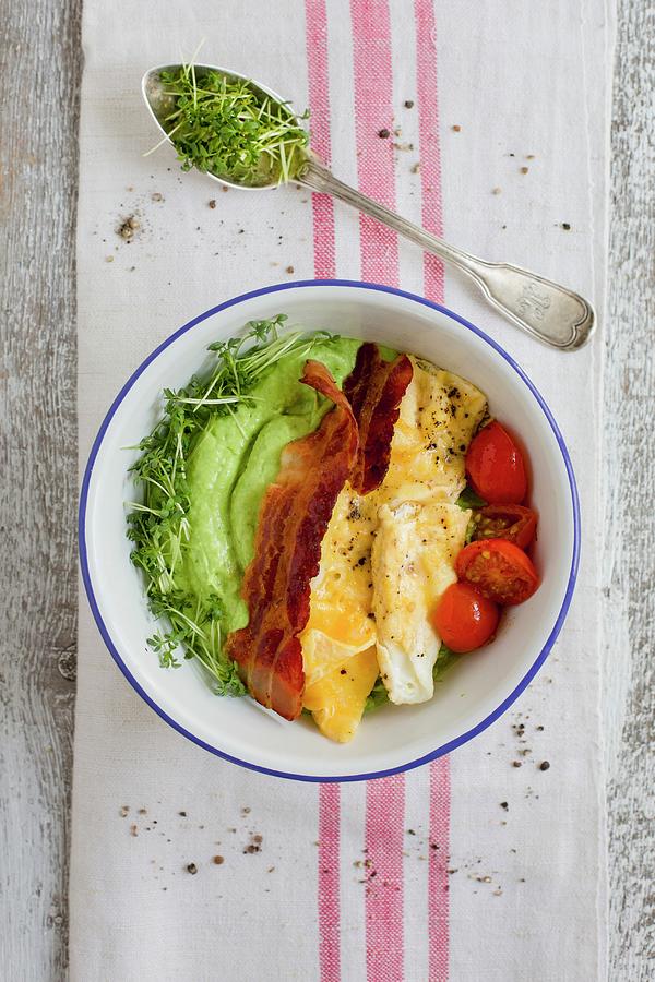 A Breakfast Bowl With Avocado And Cucumber Cream, Scrambled Eggs, Bacon And Tomatoes Photograph by Tina Engel