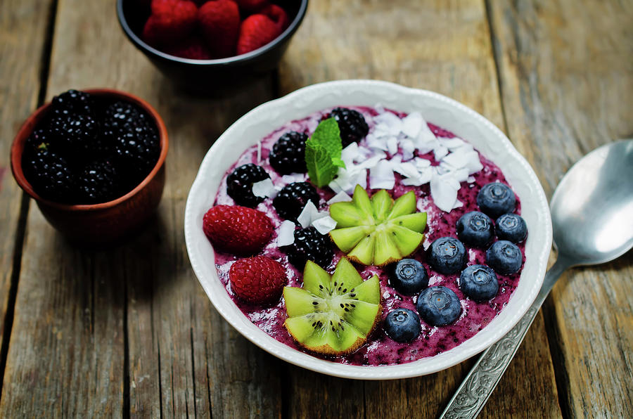 A Breakfast Bowl With Blueberry Smoothies, Blueberries, Kiwi, Raspberries, Blackberries And Coconut Flakes Photograph by Natasha Arz