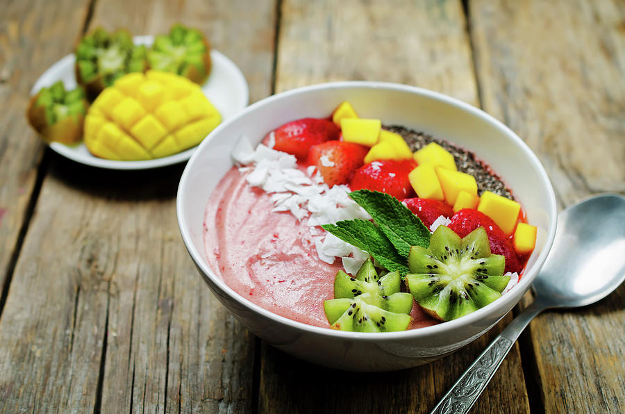 A Breakfast Bowl With Strawberry Smoothie, Kiwi, Coconut Flakes, Strawberries, Mango And Chia Seeds Photograph by Natasha Arz