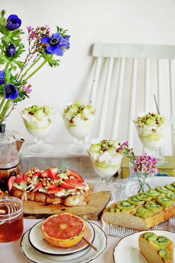 A Breakfast Buffet With Yoghurt Cups, Cake, Toast And Grapefruit Photograph by Fanny Rdvik