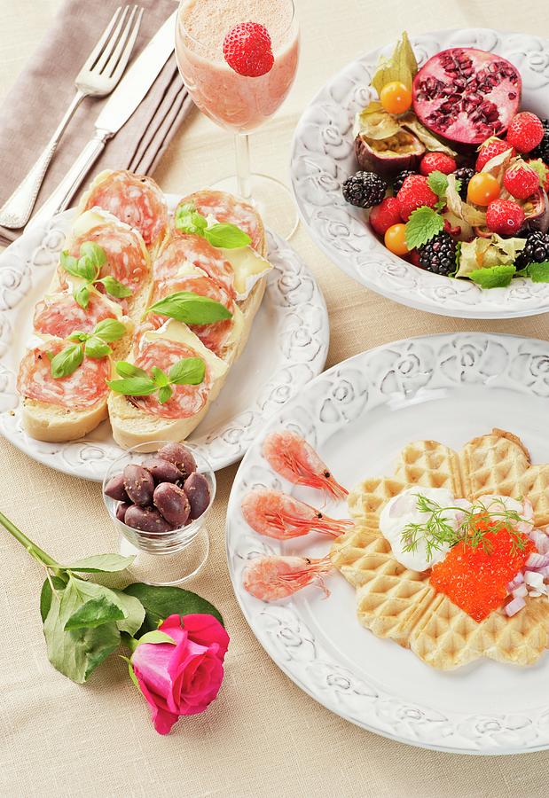 A Breakfast Of A Caviar-topped Waffle, Slices Of Bread Topped With Cheese And Ham, Fresh Fruits And A Strawberry And Mango Smoothie Photograph by Hallstrm, Lars