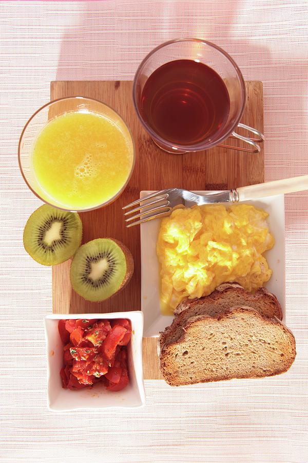 A Breakfast Of Orange Juice, Tea, Scrambled Egg And Fruit Photograph by ...