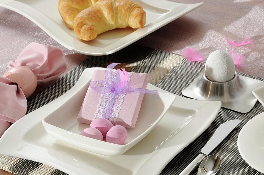 A Breakfast Place Setting With A Wrapped Present And Pink Easter Decoration Photograph by Inge Ofenstein