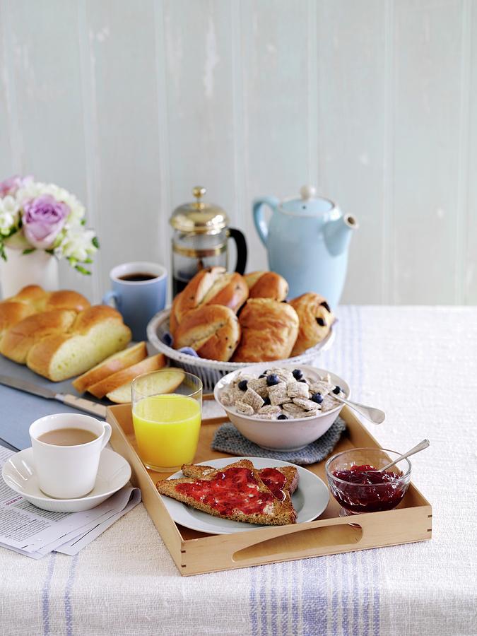 A Breakfast Tray With Toast, Cereals, Jam, Sweet Bread, Coffee And Tea Photograph by Gareth Morgans