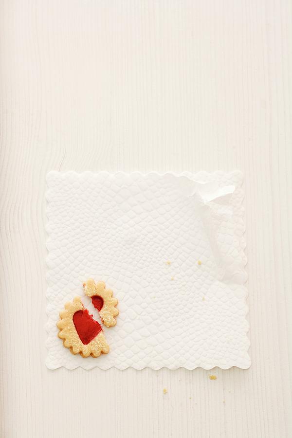 A Broken Jam Biscuit On A Doily seen From Above Photograph by Michael Wissing