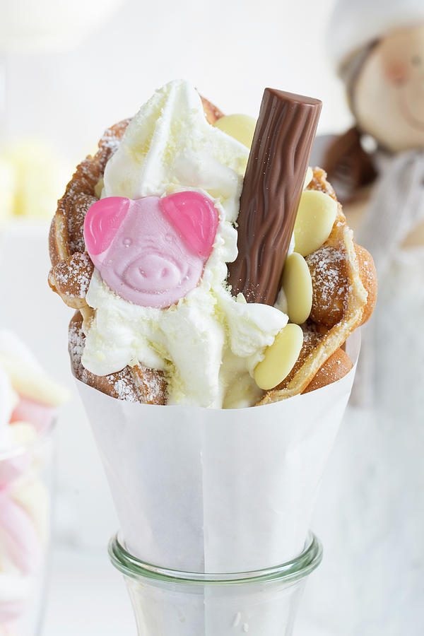 A Bubble Waffle With A Gummy Pig Sweet, White Chocolate And A Chocolate Bar Photograph by Esther Hildebrandt