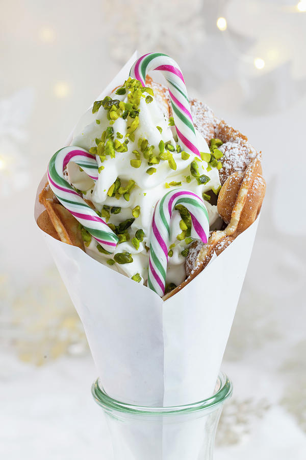 A Bubble Waffle With Frozen Yogurt, Pistachios And Striped Candy Canes For Christmas Photograph by Esther Hildebrandt