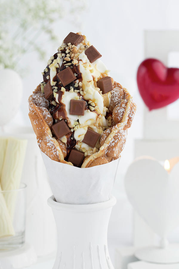 A Bubble Waffle With Hazelnuts, Chocolate Pieces And Chocolate Sauce Photograph by Esther Hildebrandt