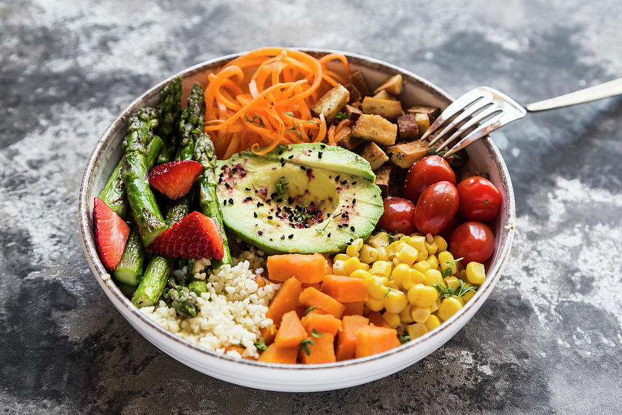A Buddha Bowl With Bulgur, Green Asparagus, Strawberries, Carrots, Tofu, Tomatoes, Sweetcorn, Sweet Potatoes And Avocado Photograph by Sandra Rsch
