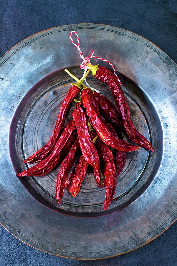 A Bunch Of Dried Red Indian Chilli Peppers On A Persian Tin Plate Photograph by Jamie Watson