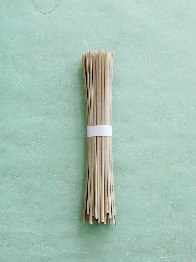 A Bunch Of Dried Udon Noodles On A Textured Background Photograph by Gareth Morgans