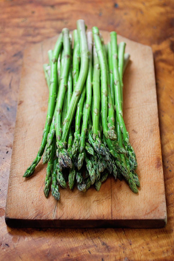A Bunch Of Fresh Asparagus On A Wooden Photograph by Kcline