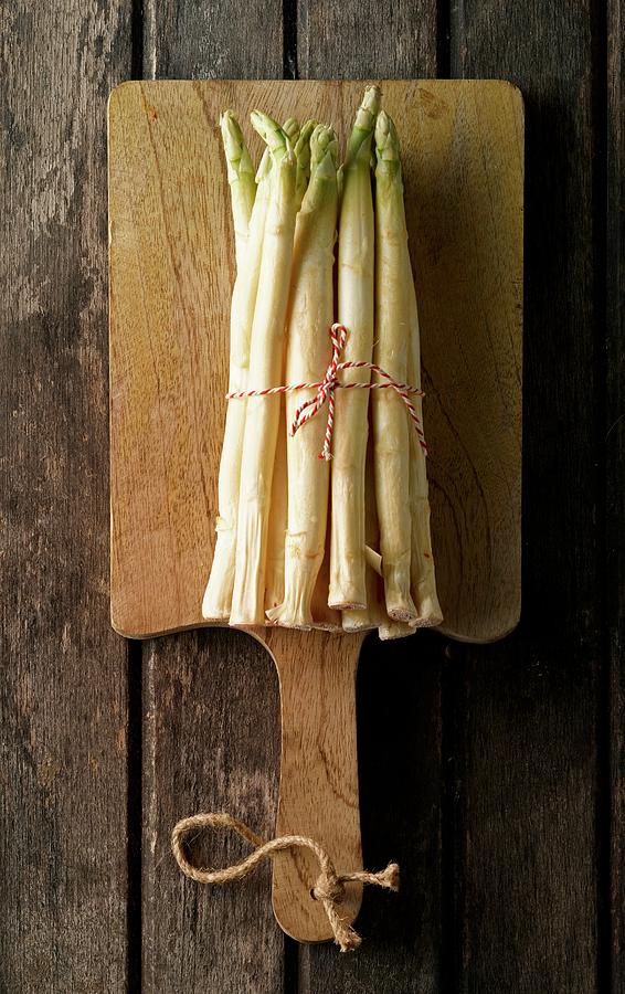 A Bunch Of Fresh White Asparagus On A Chopping Board Photograph by Ludger Rose