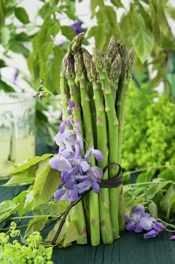 A Bunch Of Green Asparagus Decorated With Wisteria And Ladys Mantle Photograph by Martina Schindler