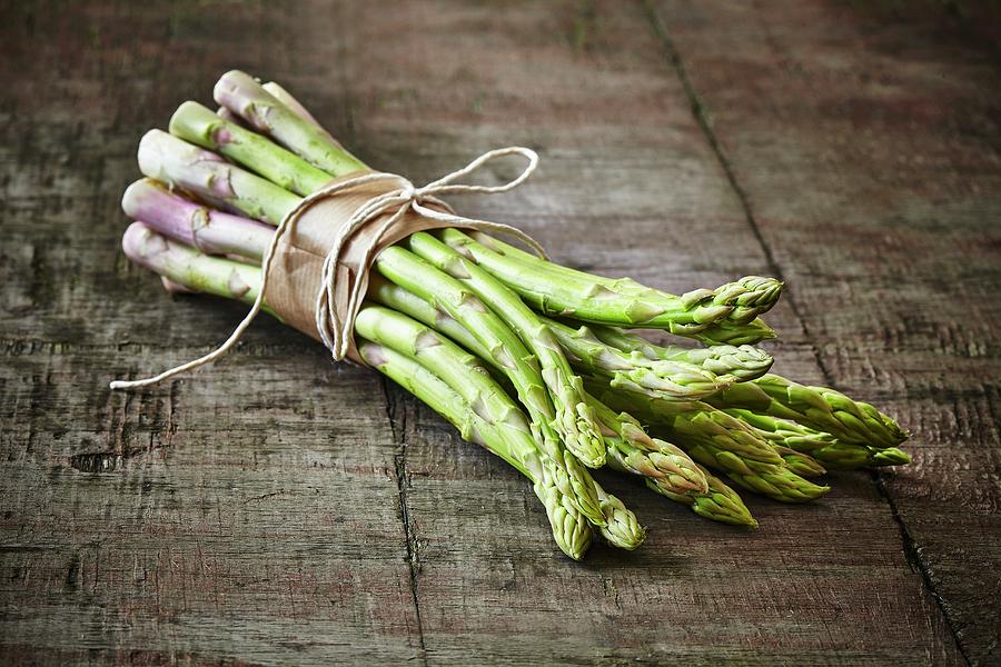 A Bunch Of Green Asparagus On A Wooden Board Photograph by Tim Atkins Photography