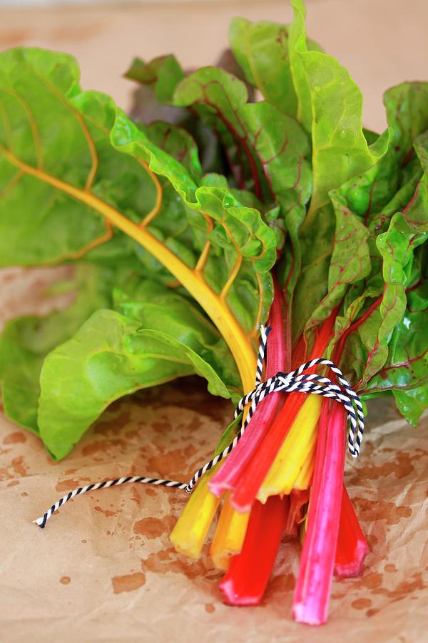 A Bunch Of Red And Yellow Chard Leaves Photograph by Carmen Mariani
