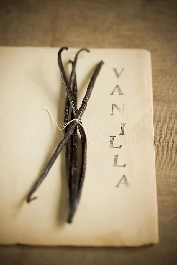 A Bunch Of Vanilla Pods Per Piece Of Paper Photograph by Colin Cooke