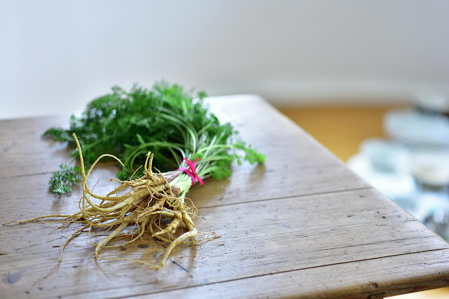 A Bunch Of Wild Carrots On A Wooden Table Photograph by Tanja Major