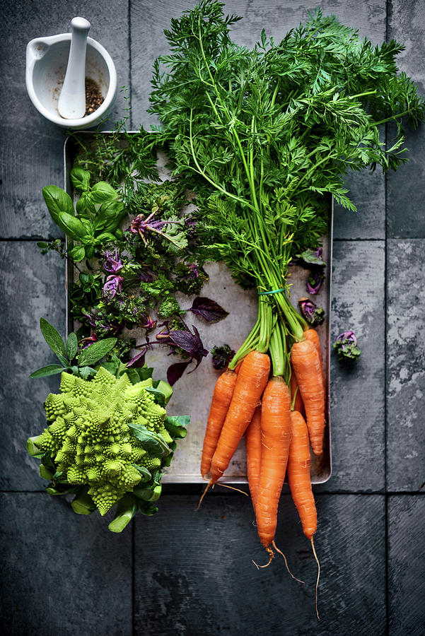A Bundle Of Carrots, Romanesco Broccoli, Brussels Sprouts And Herbs Photograph by Angelika Grossmann