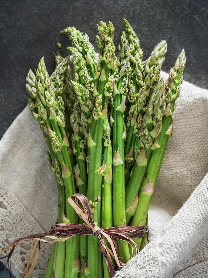 A Bundle Of Green Asparagus In A Linen Cloth Photograph by Magdalena Paluchowska