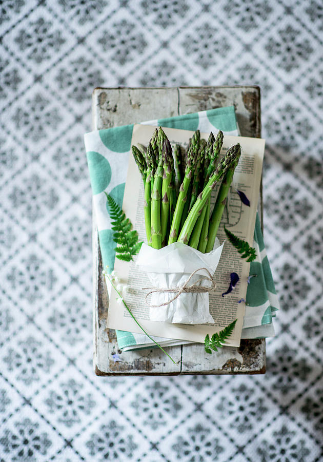 A Bundle Of Green Asparagus On A Chopping Board Photograph by Carolin Strothe