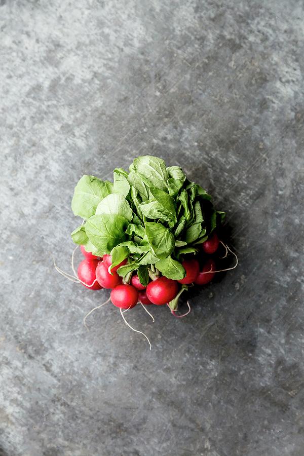 A Bundle Of Radishes On Grey Surface Photograph by Sarah Coghill