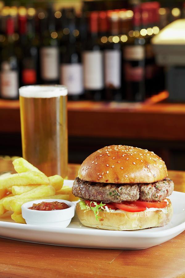 A Burger With Chips, Tomato Sauce And A Pint Of Beer Photograph by Charlotte Tolhurst