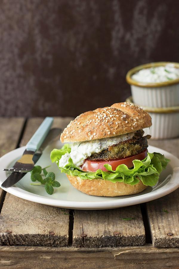 A Burger With Fried Aubergine, Tzatziki, Tomato And Lettuce Photograph by Zuzanna Ploch