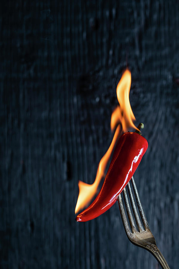 A Burning Chili Pepper On A Fork Photograph by Derek Bissonnette