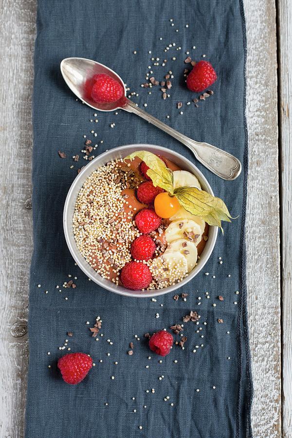 A Cacao Smoothie Bowl With Raspberries, Banana And Popped Amaranth Photograph by Tina Engel