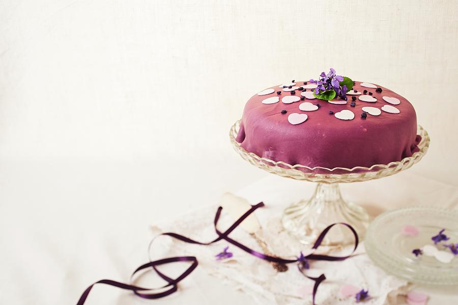 A Cake With A Violet Marzipan Coating Photograph by Hannah Kompanik