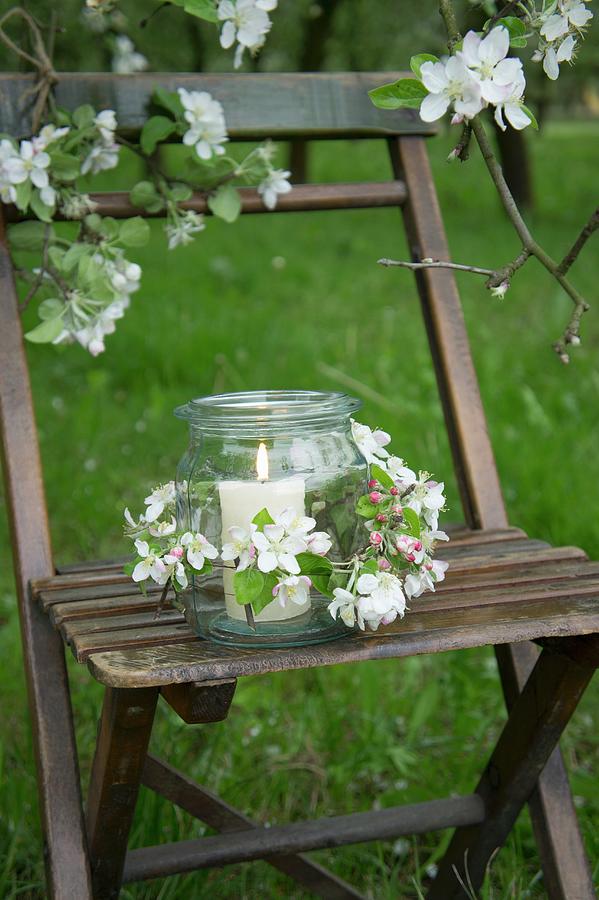 A Candle Holder On A Chair Decorated With Apple Blossom Photograph by Martina Schindler