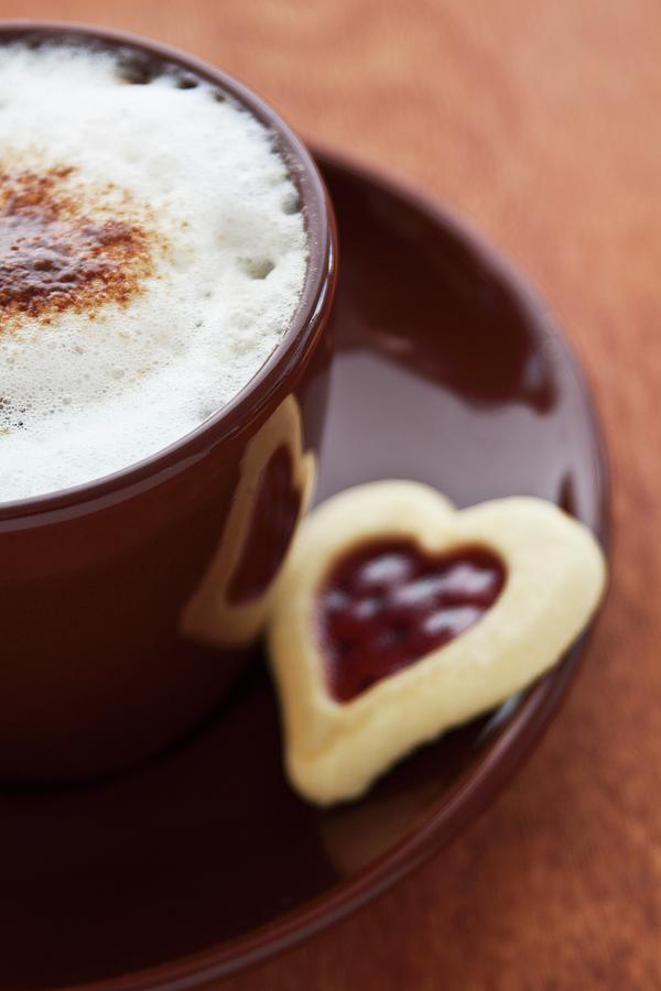 A Cappuccino And A Jam Biscuit Photograph by Uwe Merkel