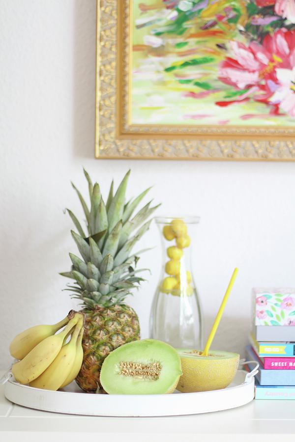 A Carafe Of Water, Bananas, Pineapple And Half A Melon On A Tray Photograph by Sylvia E.k Photography