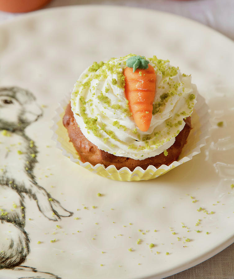 A Carrot Cupcake With Butter Cream, Pistachios And A Marzipan Carrot Photograph by Labsalliebe