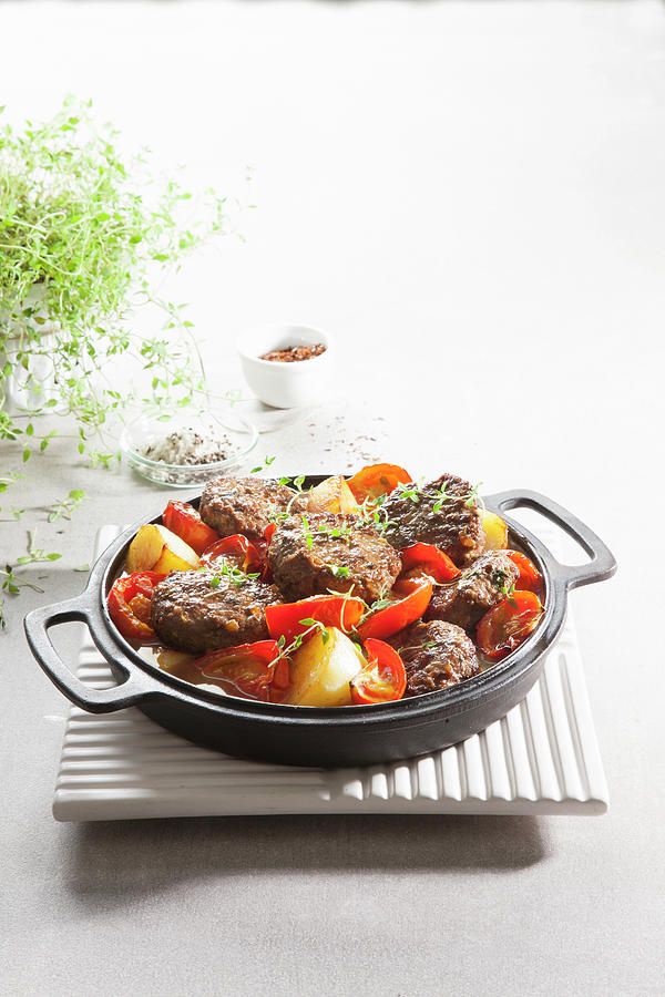 A Casserole With Pistachio And Mince Kebabs, Tomatoes And Potatoes Photograph by Danny Lerner