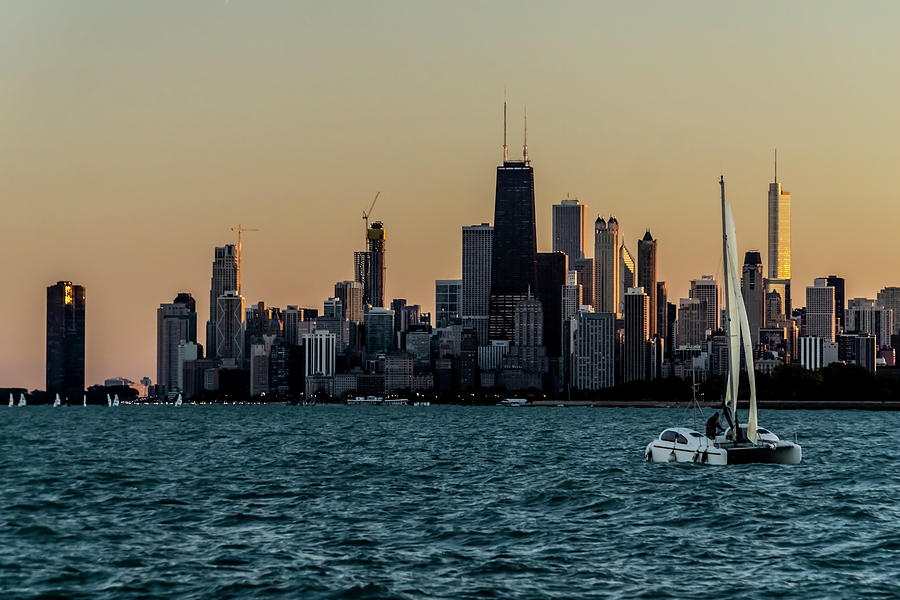 A Catamaran at sunset in front of the Chicago Skyline Photograph by Sven Brogren
