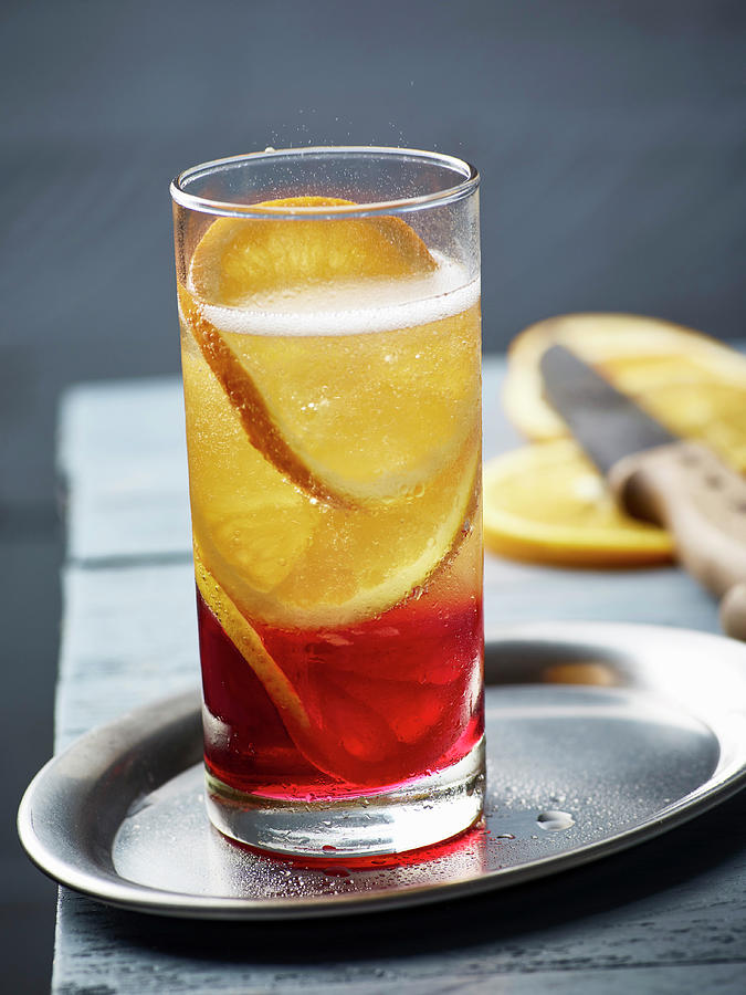 A Champagne Cocktail With Campari Photograph by Peter Rees