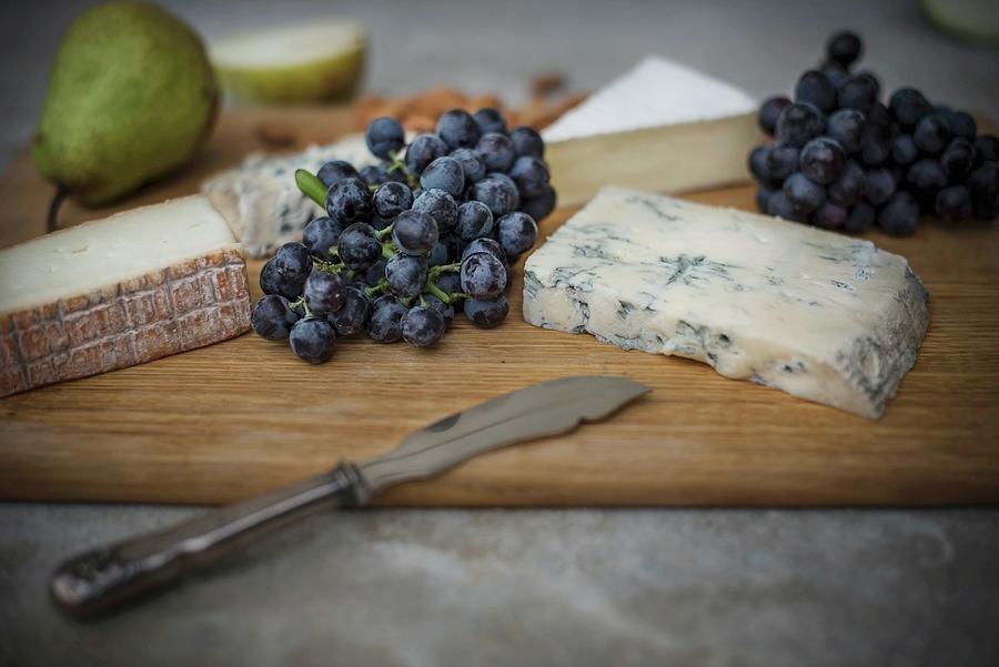 A Cheese Board With Grapes And Pear Photograph by Justina Ramanauskiene