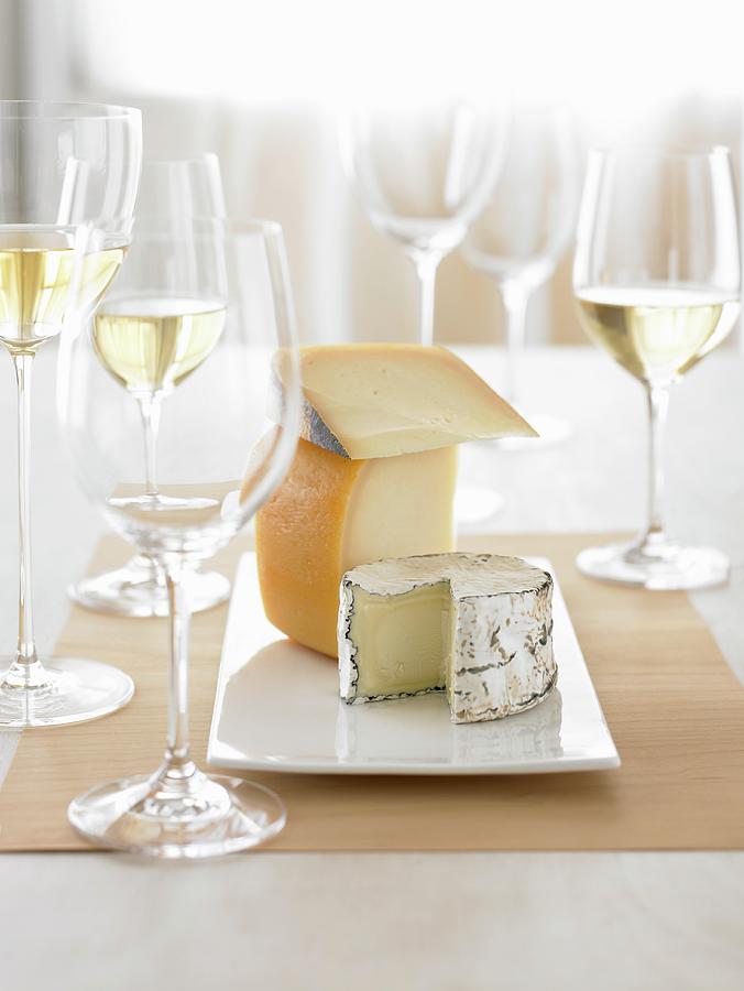 A Cheese Platter And Glasses Of White Wine Photograph by Leigh Beisch
