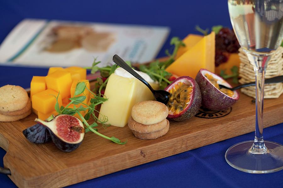 A Cheeseboard With Biscuits, Figs And Watercress Photograph by Creative Photo Services