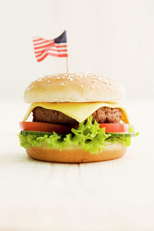 A Cheeseburger Decorated With An American Flag Photograph by Michael Wissing
