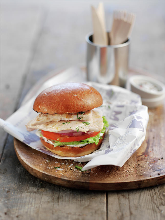 A Chicken Burger With Tomato And Salad Photograph by Ian Garlick