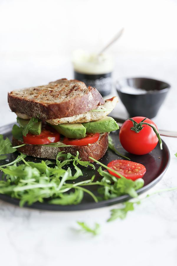 A Chicken Sandwich With Tomato, Avocado And Rocket Photograph by Eva Lambooij