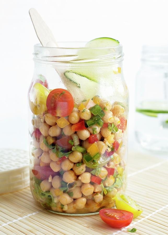 A Chickpea Salad In A Glass Jar With Tomatoes, Peppers, Red Onions, Spring Onions, Spices, Limes, Olive Oil And Fresh Parsley Photograph by Etienne Voss
