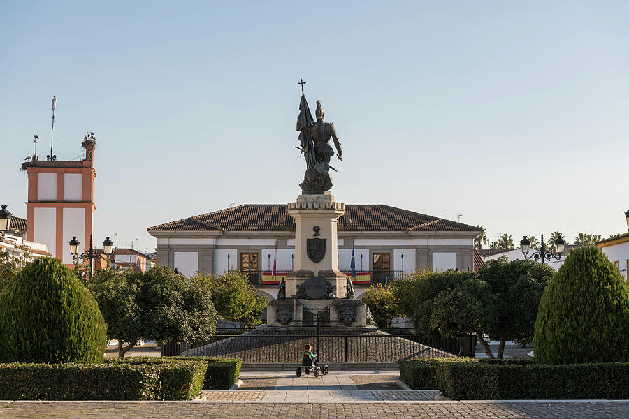 A Child Plays In The Plaza De Hernan Cortes Where You Can See A Statue Of The Spanish Conquerormedel Photograph