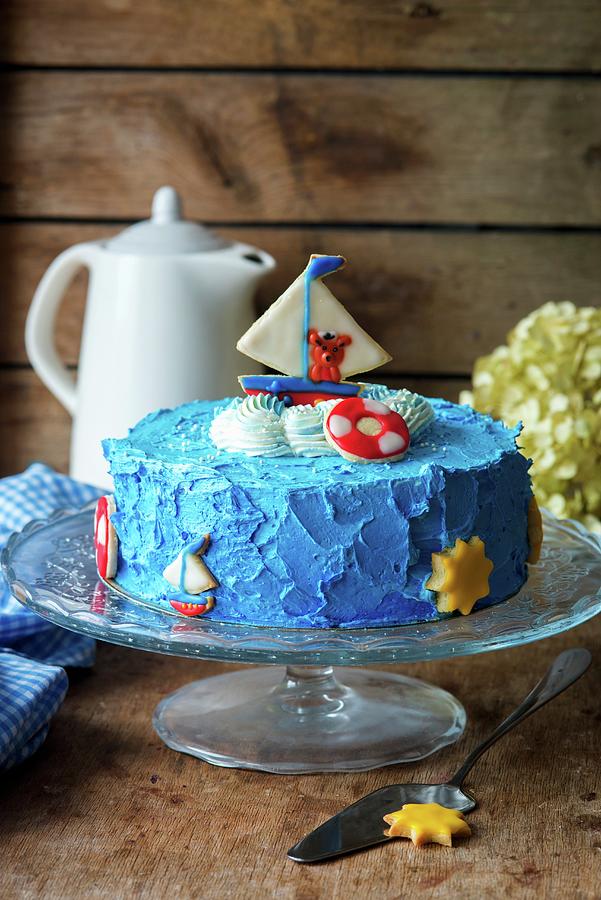 A Childrens Cake Decorated With A Sailing Boat And A Bear Photograph by Irina Meliukh