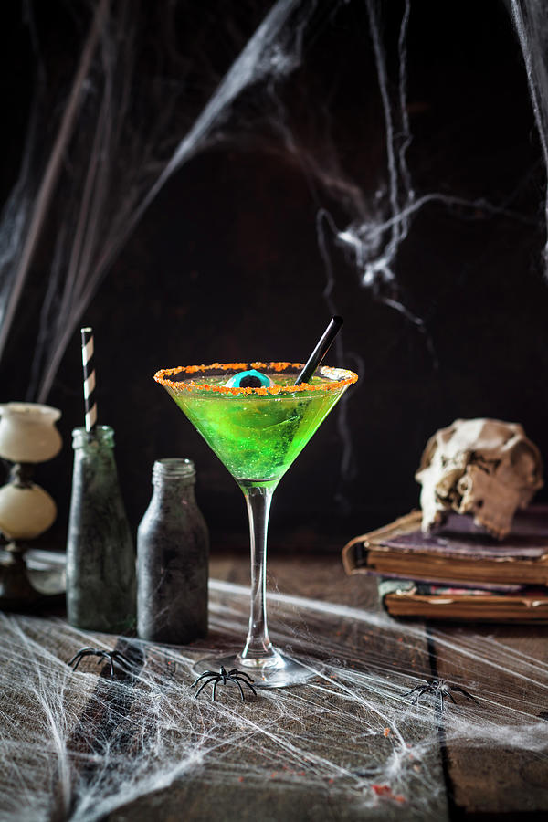 A Childrens Cocktail Made From Green Jelly And Apple Juice Decorated With An Eye Sweet For Halloween Photograph by Susan Brooks-dammann